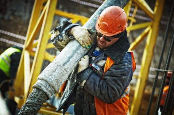 construction worker lifting heavy object