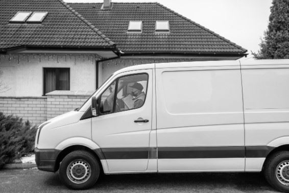 delivery driver parked outside a house